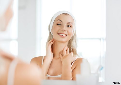 A woman enjoying the results of her neck lift, which eliminated vertical banding.